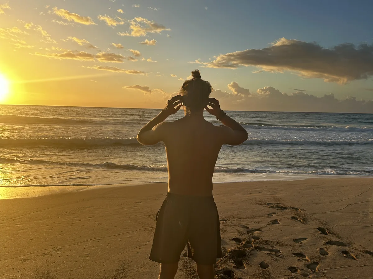 Alex facing the ocean at sunset while fitting a SubMergence headset